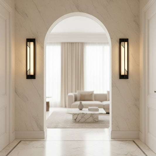 Lorvali linear wall sconces with copper frames and marble shades mounted on a marble archway in a modern living room.