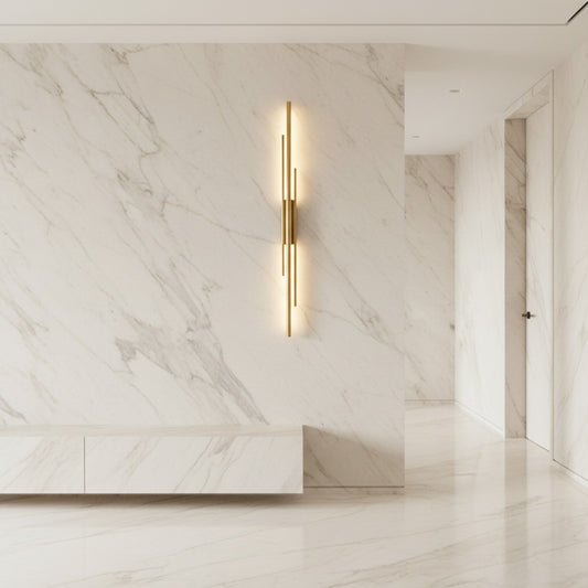 Lorvali contemporary linear wall sconce in solid copper mounted on a white marble wall with warm LED lighting.