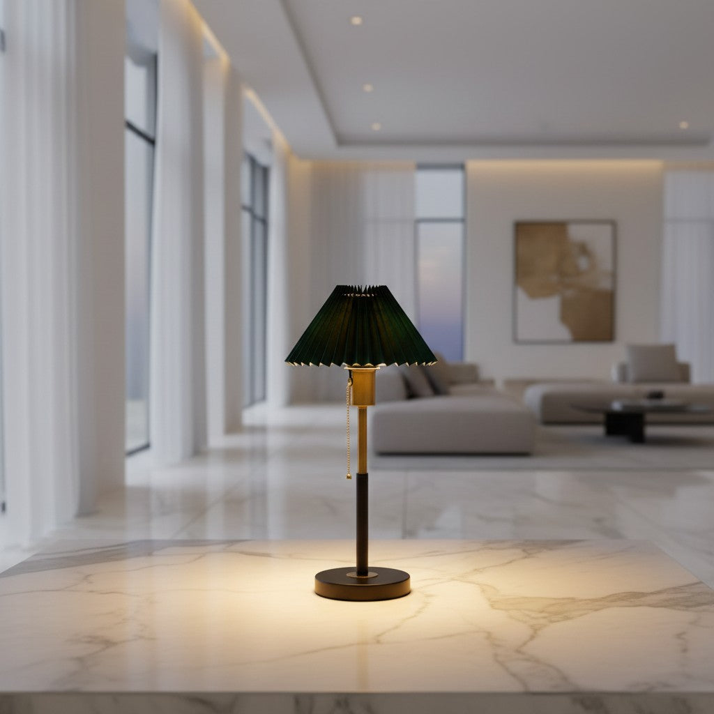Lorvali Lumi Pleated Table Lamp with a green pleated shade and a black and gold metal base on a marble surface.