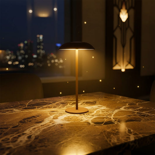 Lorvali contemporary LED table lamp with a minimalist design, glowing on a marble table against a city night backdrop.