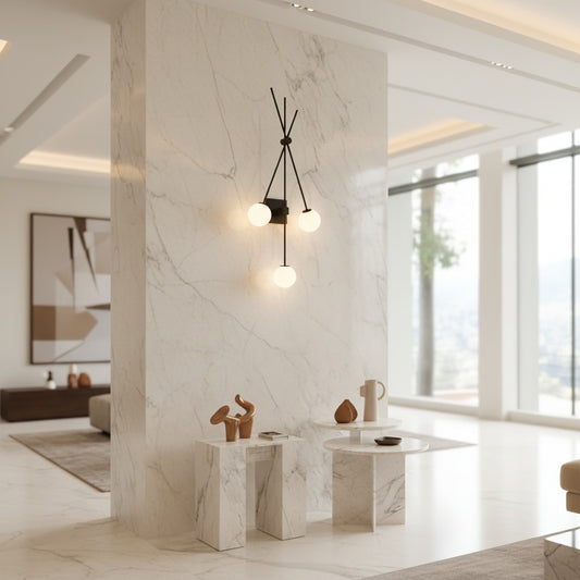 Lorvali modern black iron double sconce wall light with three glowing glass globes mounted on a marble pillar.