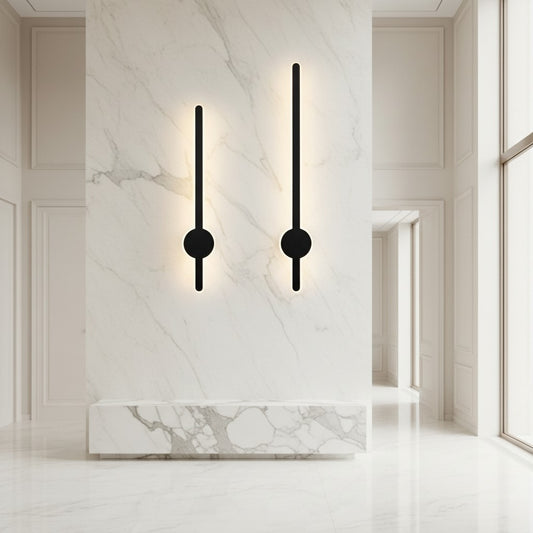 Lorvali modern black LED bar wall sconces mounted on a white marble wall in a minimalist interior.
