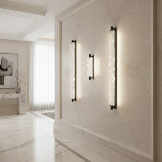 Lorvali modern minimalist wall sconces with chrome metal and crystal accents glowing with warm LED light in a hallway.
