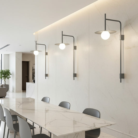 Lorvali modern industrial wall sconces with long arms and frosted glass globe shades mounted in a bright dining room