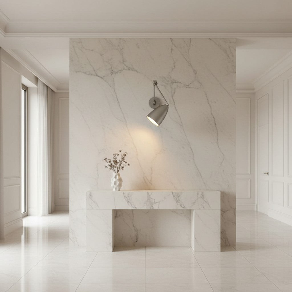 Lorvali modern metal swing arm wall light with adjustable joints mounted on a white marble wall above a console table.