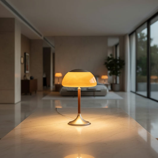 Lorvali Mofu Dome table lamp with a rounded orange glass shade and slender stem on a marble surface in a modern room