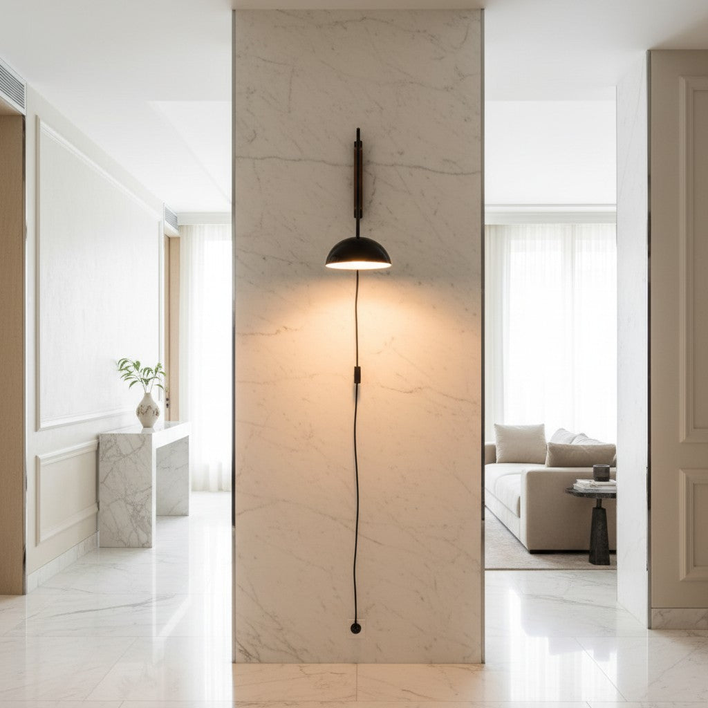 Lorvali Nordic swing arm wall lamp with a black iron shade mounted on a white marble pillar in a modern living room.