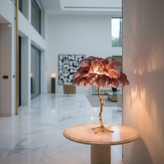 Lorvali palm tree table lamp with pink ostrich feathers and a polished brass base in a modern living room