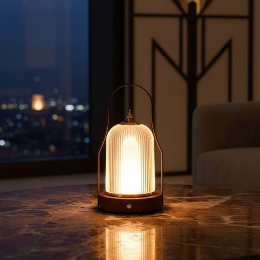 Lorvali portable rechargeable LED lantern with a ribbed white acrylic shade and brass handle on a marble table