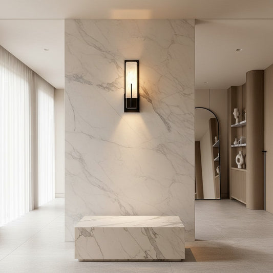 Lorvali rectangular wall sconce with a copper frame and cloud stone shade, emitting warm LED light on a marble wall.