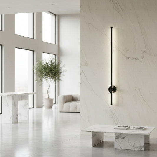 Lorvali rotatable LED wall lamp with a sleek black metal finish and acrylic shade on a marble background wall