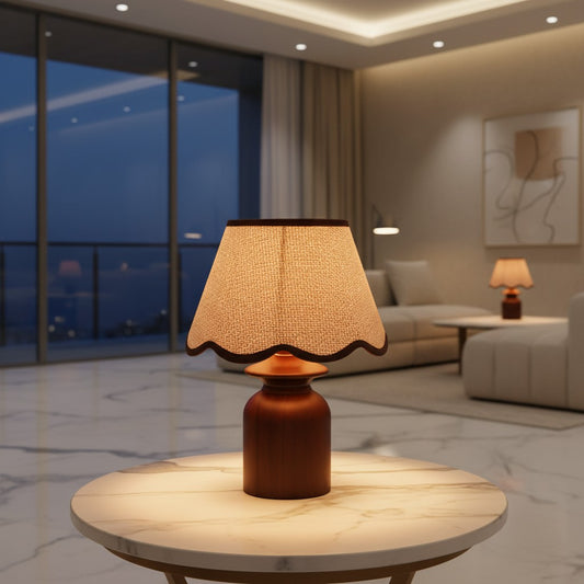 Lorvali Rowanl table lamp with a walnut rubber wood base and a beige linen scalloped shade on a marble side table