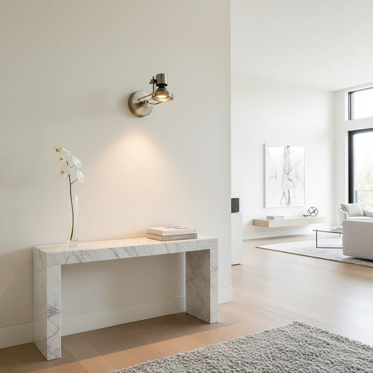 Lorvali industrial silver die-cast aluminum wall light mounted above a marble console table in a modern living room.