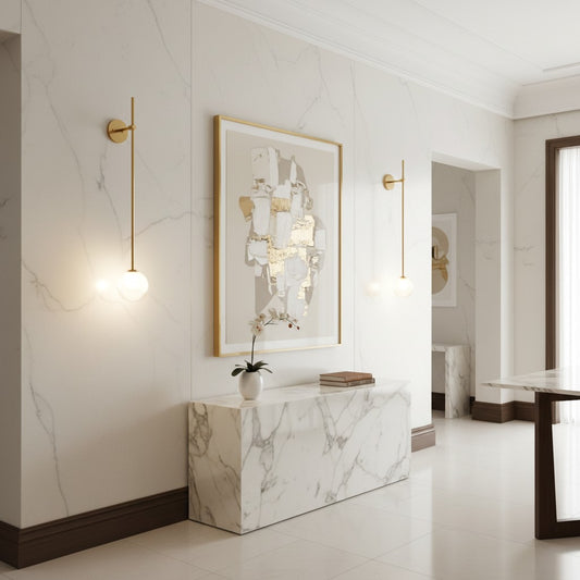 Lorvali modern wall sconces with slim gold arms and bubble glass globes illuminating a marble hallway interior.