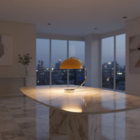 Lorvali Solaris Arc Table Lamp in yellow with a polished chrome arch on a white marble table in a modern room
