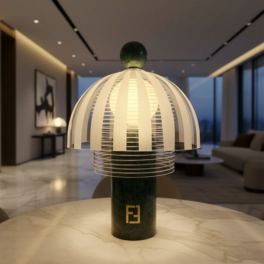 Lorvali Striara marble dome table lamp with a green marble base and modern clear glass shade on a marble table.