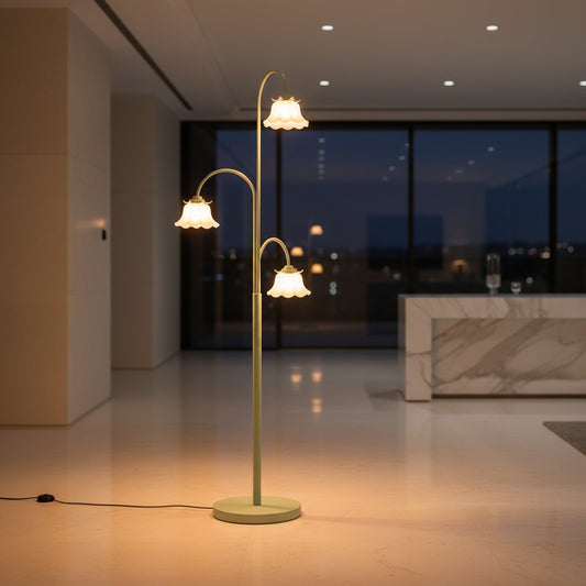 Lorvali tulip floor lamp with three glass flower shades on a curved green iron frame in a modern living room.