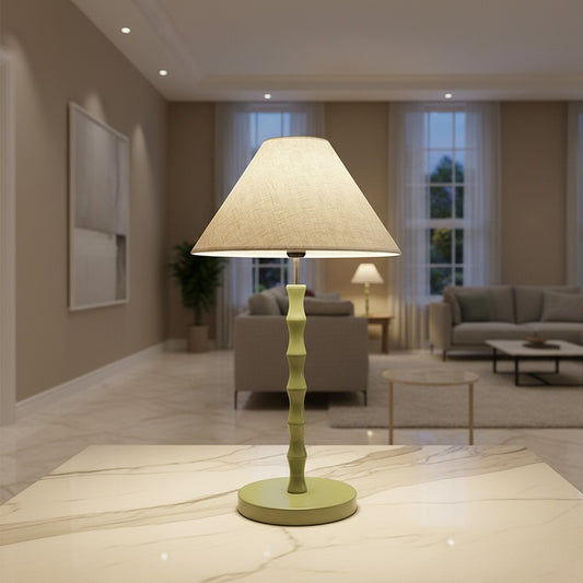 Lorvali Vincent Joint Table Lamp in green with a bamboo-inspired iron base and fabric shade on a marble table.