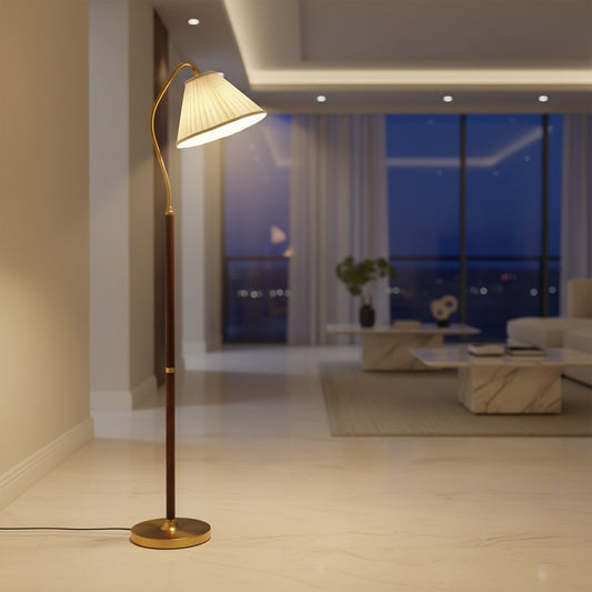 Lorvali walnut floor lamp with a white pleated fabric shade and a slim wood and gold metal stand in a modern living room