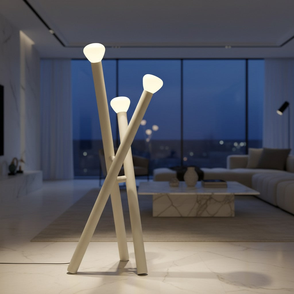 Lorvali minimalist 3-light floor lamp in matte white with crossed stick design and milky glass shades in a living room.