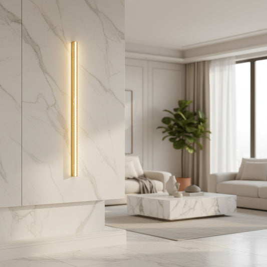 Lorvali yellow travertine LED wall lamp with a slim, vertical wabi-sabi design mounted on a marble living room wall.